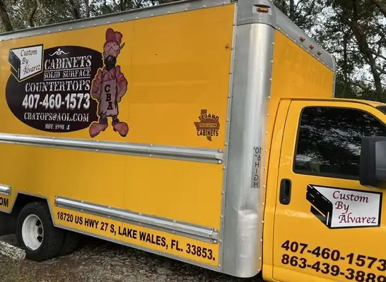 Yellow Custom By Alvarez box truck with cabinets, solid surface and countertops lettering